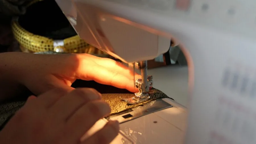 Tailor measuring fabric with flexible tape for custom clothing alterations and pattern fitting