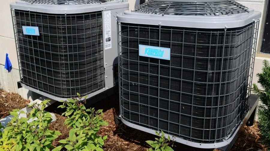 Technician measuring temperature during HVAC maintenance work in residential setting