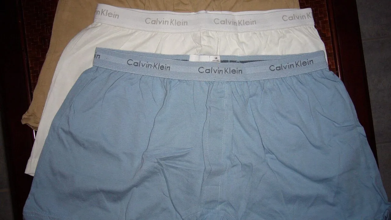 Thermal underwear set displayed flat showing long sleeve top and bottom pants in neutral colors