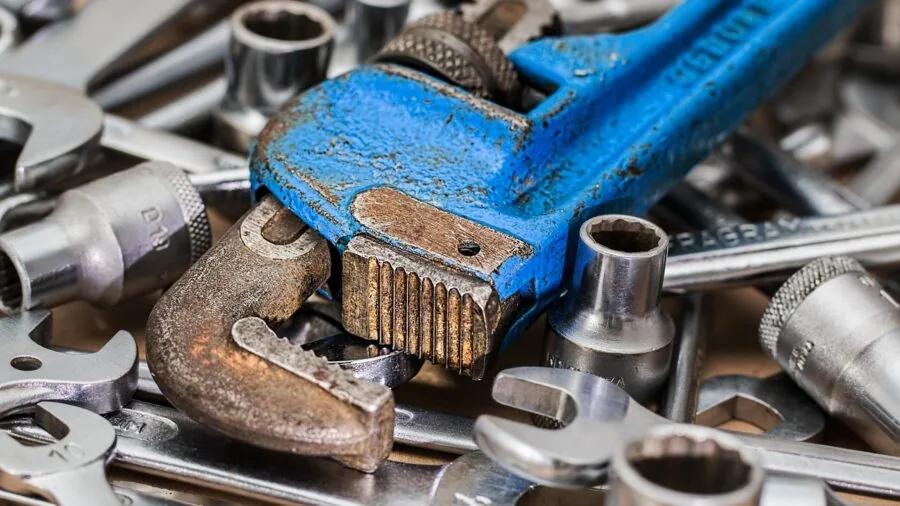 Tools and parts spilling from an open toolbox onto a workshop floor, emphasizing the need for secure storage solutions
