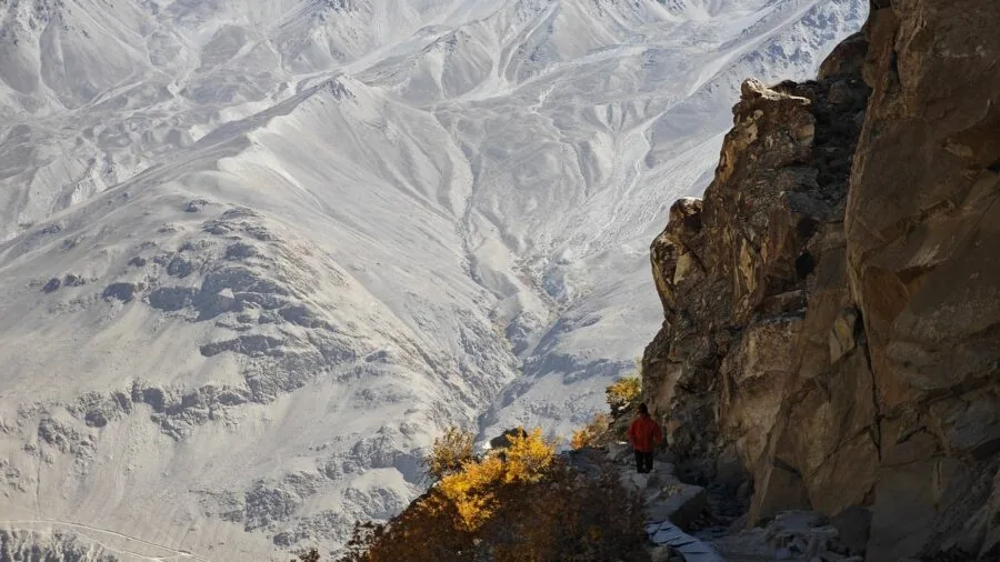 Trail runner navigating rocky mountain terrain with worn shoes on rugged outdoor path