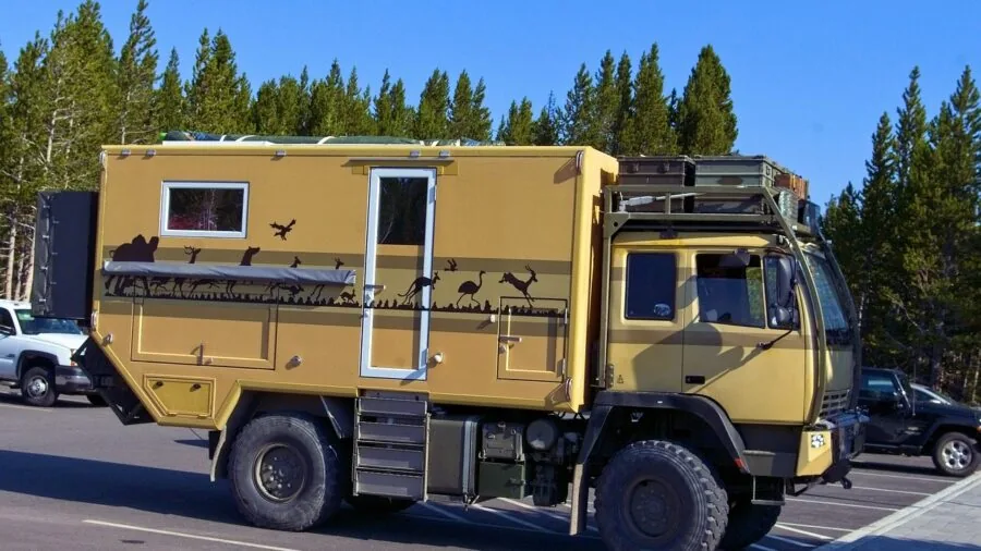 Traveler boarding recreational vehicle during outdoor camping trip