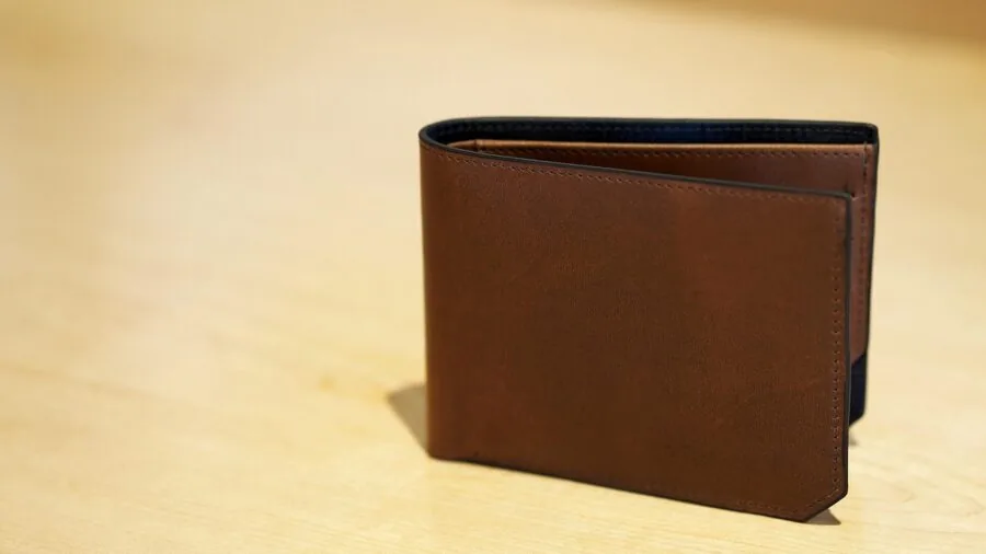 Traveler organizing credit cards and cash in wallet for trip planning