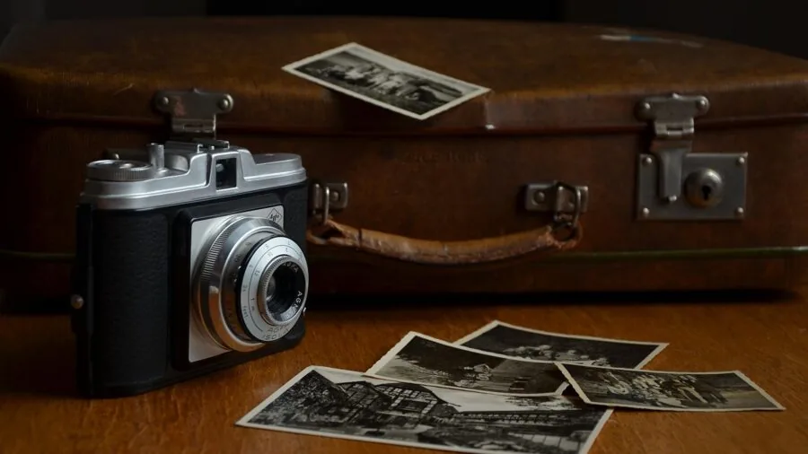 Traveler packing lightweight photography equipment into a compact backpack for a trip
