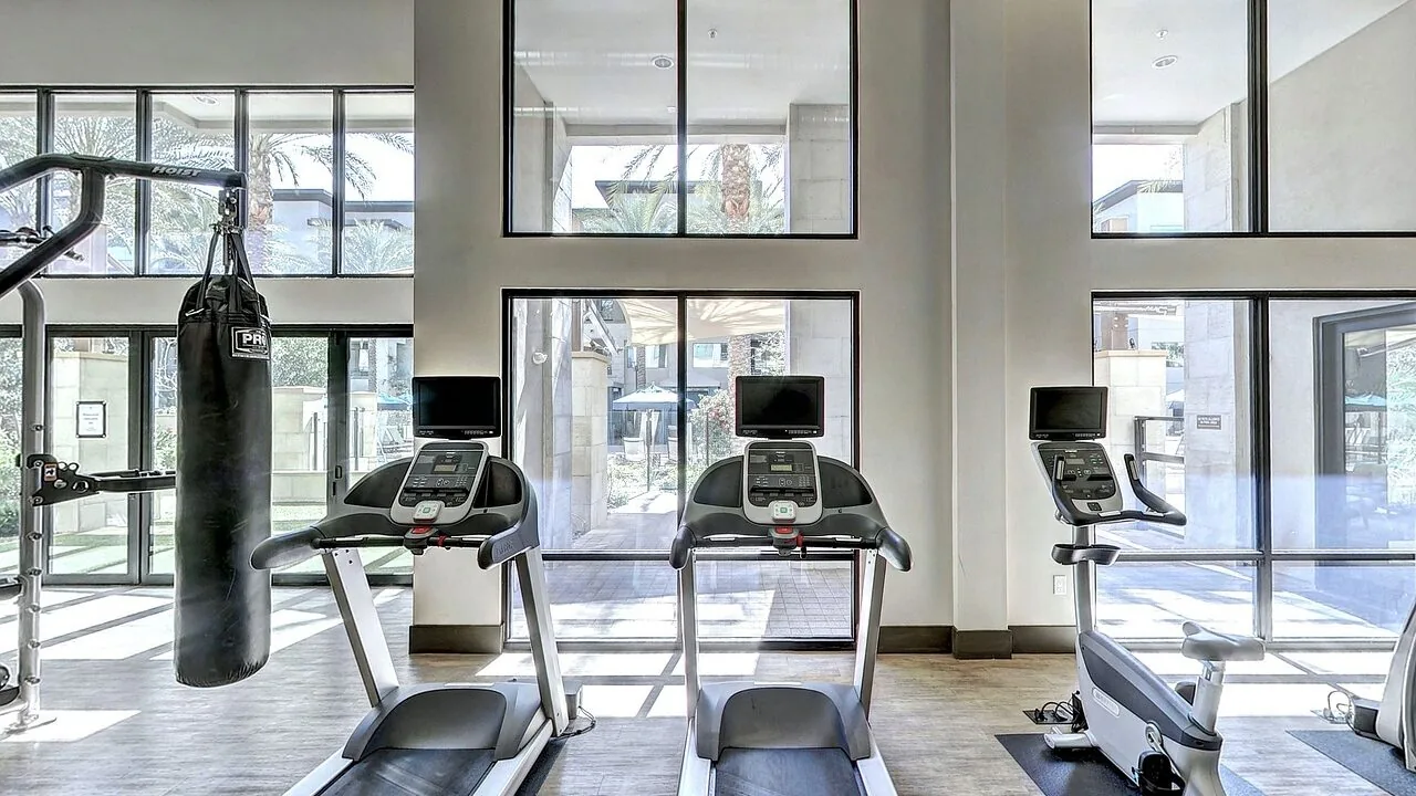 Treadmill positioned in a home gym setting with modern equipment