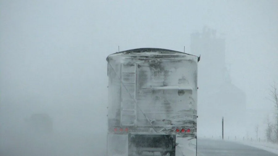 Truck traveling on highway through varying weather conditions and road terrain