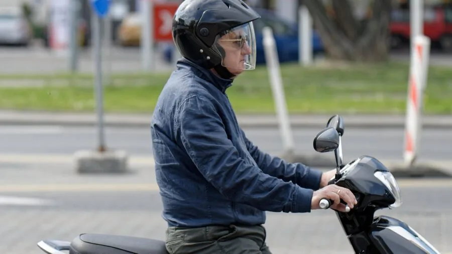 Two motorcyclists riding together on open road, representing wireless communication between riders