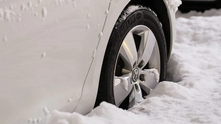 Vehicle on snowy mountain road during winter conditions, demonstrating traction challenges