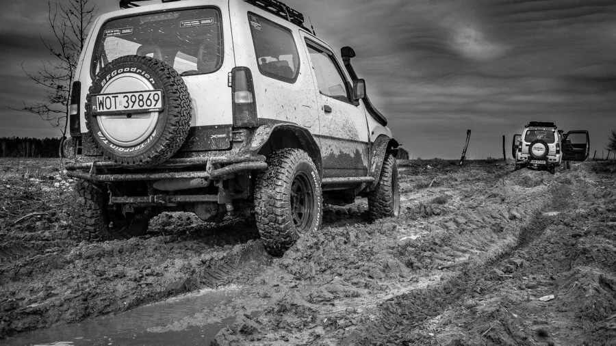 Vehicle tires gaining traction on muddy terrain during off-road driving