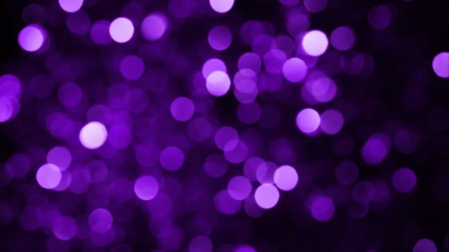 Vibrant colored lights illuminating a crowded dance floor at a nighttime party or club event