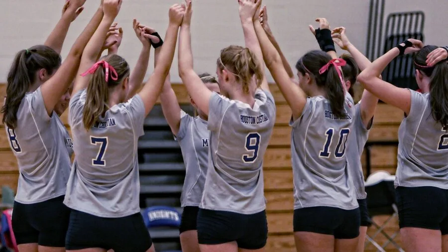 Volleyball player in action during practice, demonstrating ball control and durability through repeated contacts on indoor court