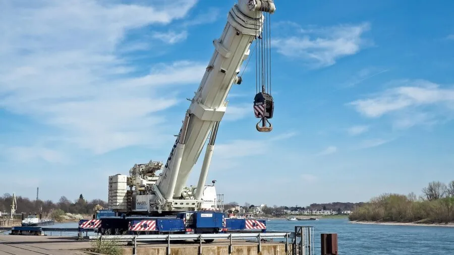 Warehouse worker operating equipment to lift and move heavy commercial cargo safely