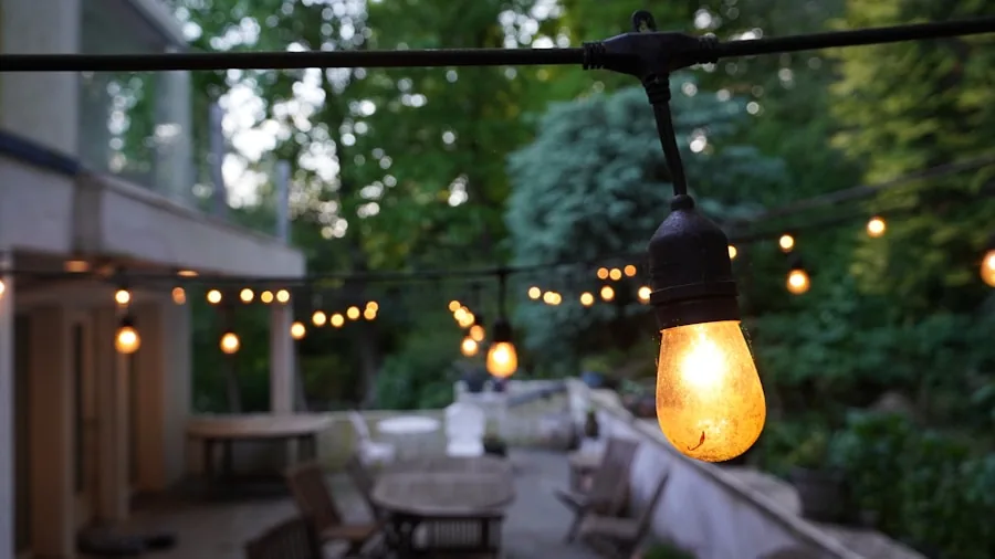 Warm string lights creating ambient glow over outdoor patio seating area at dusk