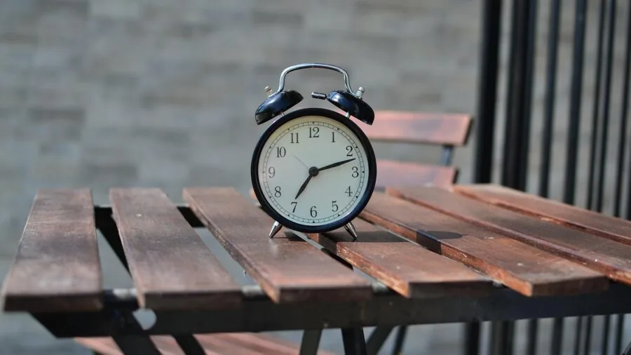 Weathered metal furniture on a backyard patio showing rust and outdoor wear patterns
