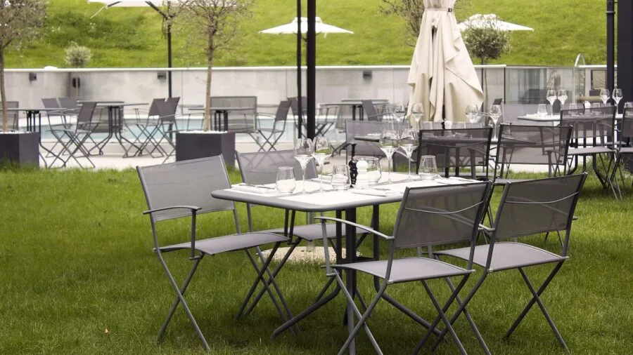Weathered patio umbrella showing fabric fading and UV damage from prolonged sun exposure