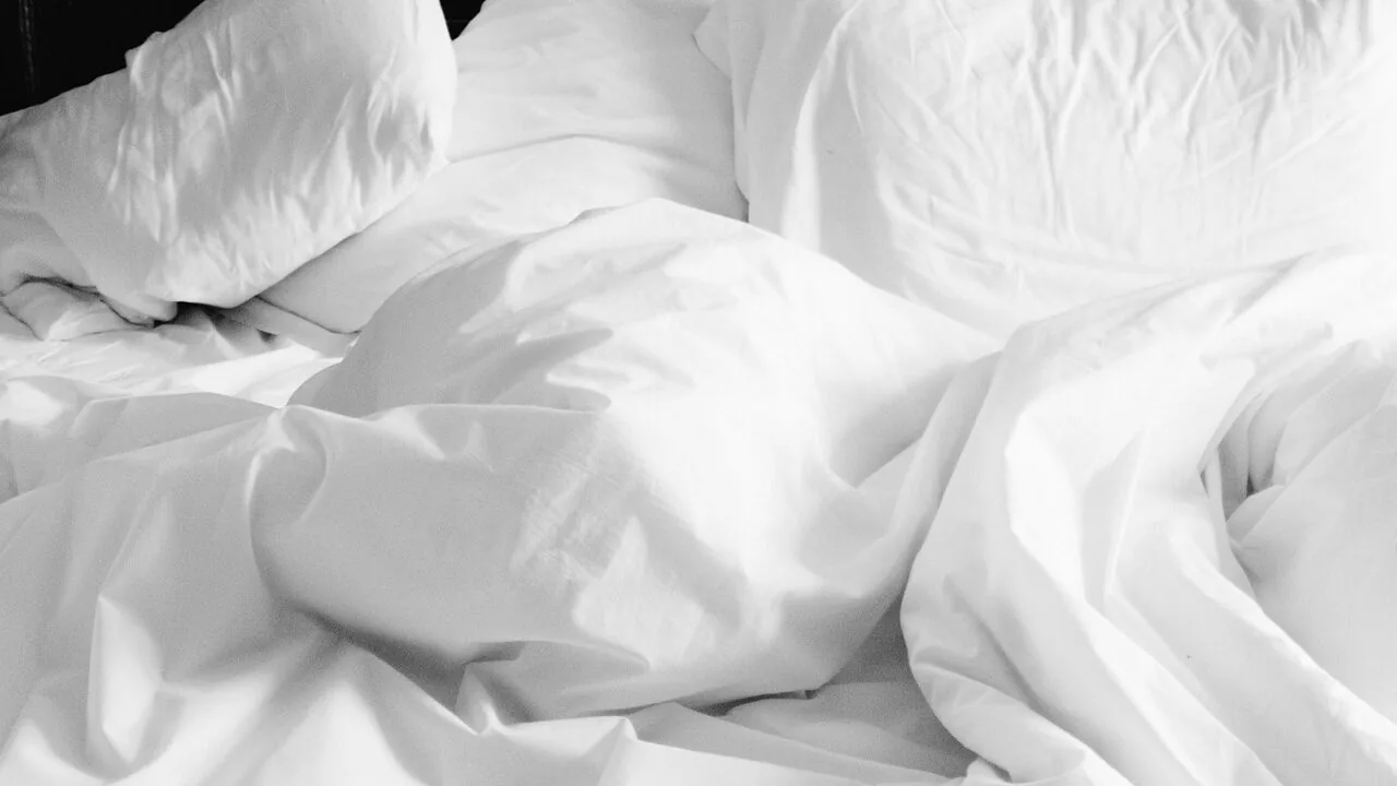 Weighted blanket spread across a bed in a bedroom setting