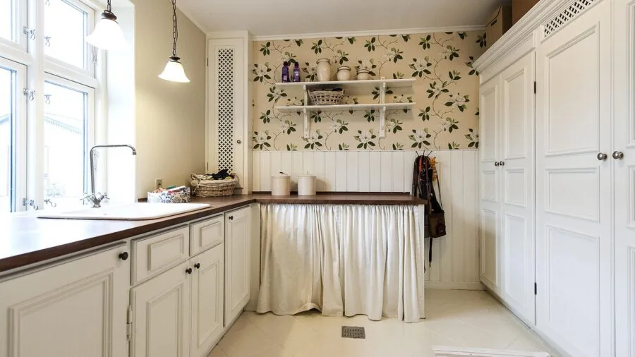 Well-organized kitchen cabinet with neatly arranged items on shelves showing practical storage solutions
