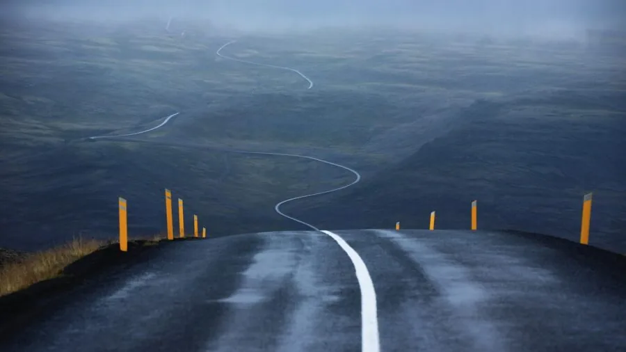 Windy highway conditions with vehicles traveling in challenging weather demonstrating road stability needs