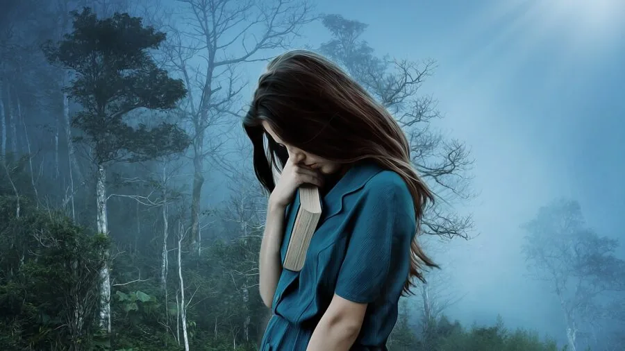 Woman applying body mist to hair and skin in natural lighting, demonstrating multi-use product application