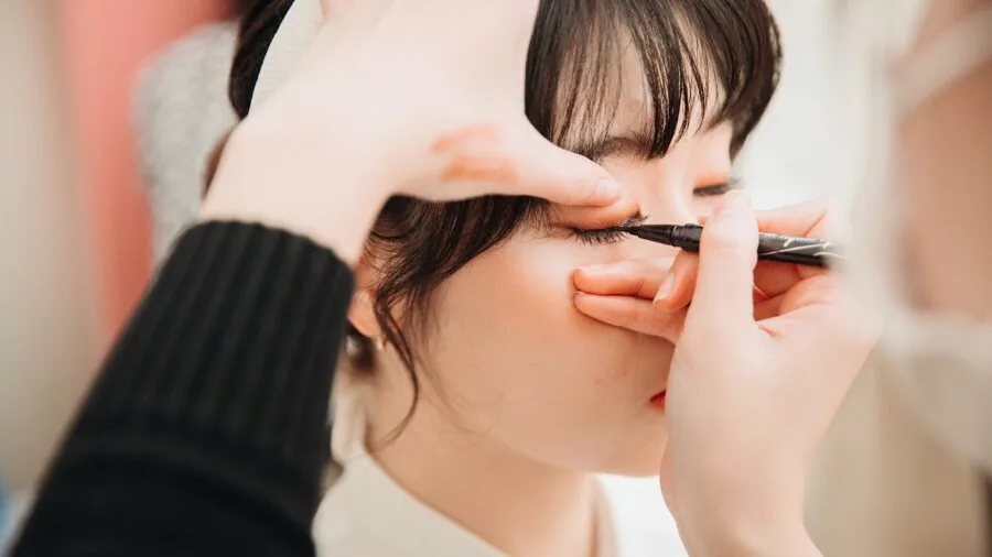 Woman applying fragrance and preparing for evening out, lifestyle scene