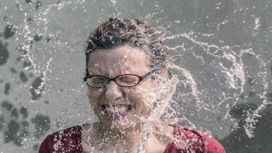 Woman applying ice pack to face for cooling and comfort relief during skincare routine