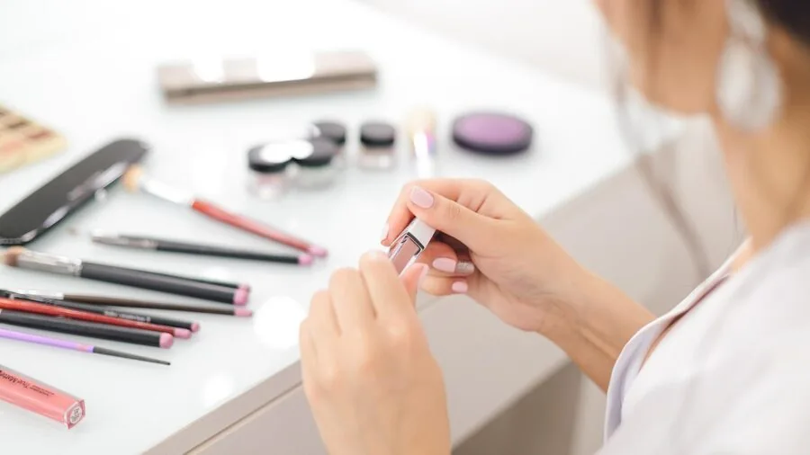 Woman applying skincare products while looking in bathroom mirror during morning routine