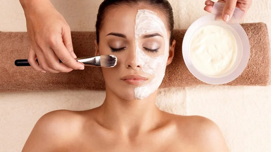 Woman applying skincare with beauty tools as part of complete facial care routine