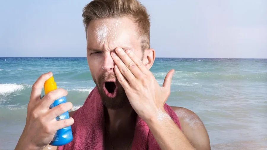 Woman applying sunscreen to her hands for UV protection outdoors