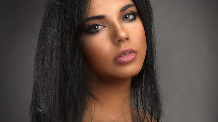 Woman brushing through dark hair to remove product buildup and residue