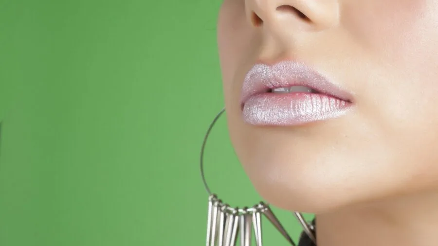 Woman carefully applying lip liner with precision brush for even pigmentation and color coverage
