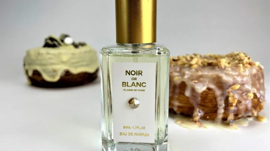 Woman carefully applying roll-on perfume to her neck and wrist in natural daylight
