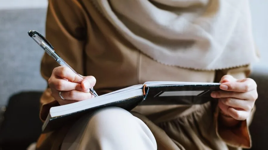 Woman carefully reviewing skincare product information and credentials before purchase decision