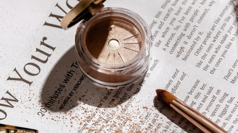 Woman comparing makeup products while looking in mirror, considering quality and value choices