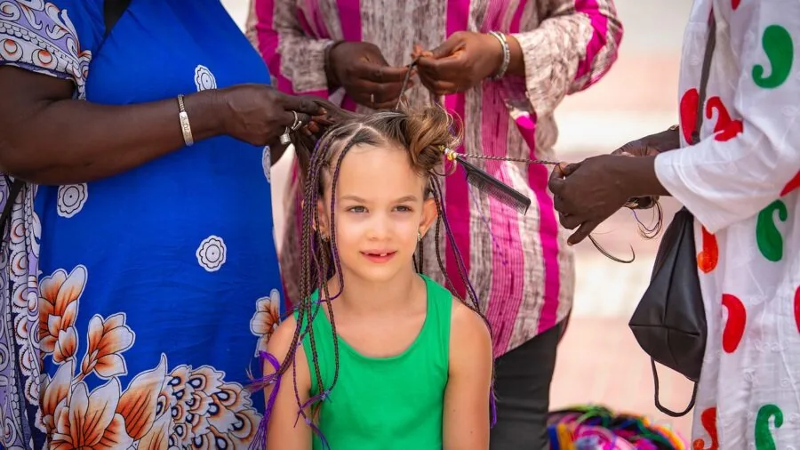 Woman creating different hairstyles with a flat iron, demonstrating versatile styling techniques on her hair