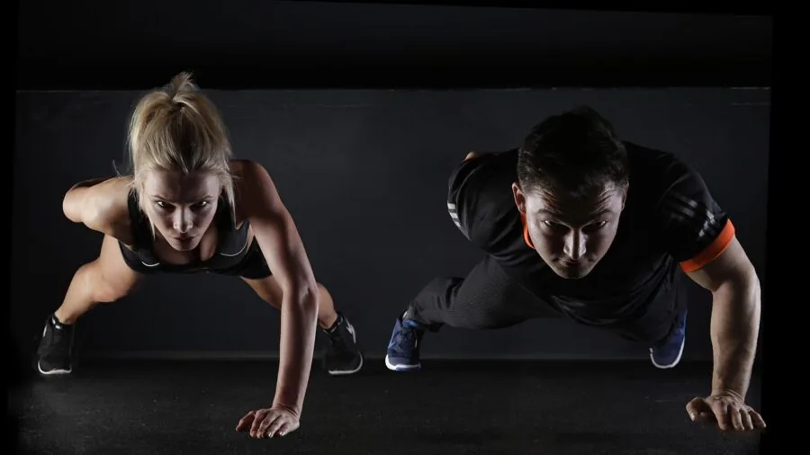 Woman doing step aerobic exercise at home on a budget-friendly stepper platform
