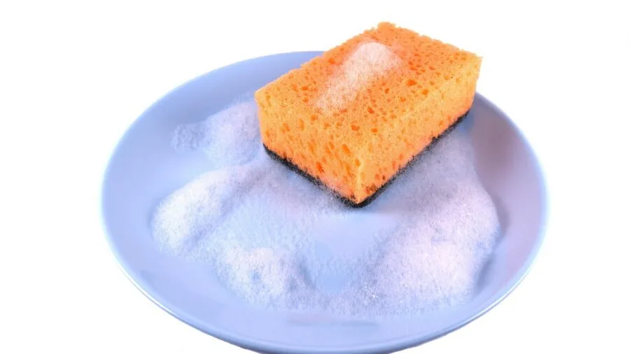 Woman enjoying a relaxing bath with lather and sponge in a spa-like bathroom setting