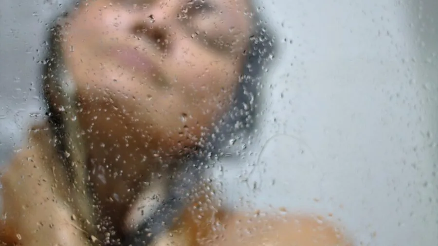 Woman enjoying a relaxing bath with natural skincare ingredients and soothing atmosphere
