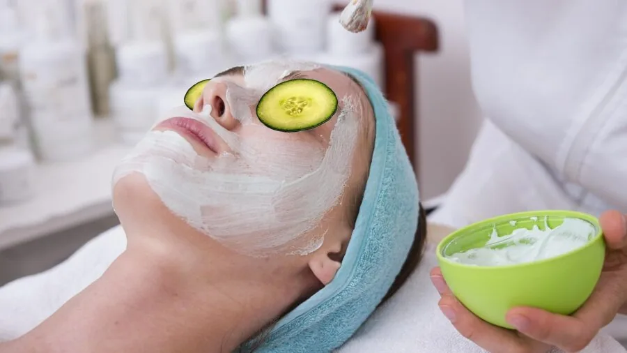 Woman enjoying a relaxing spa facial treatment at home, demonstrating comfort during skincare routine