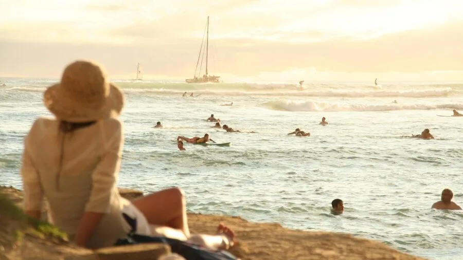 Woman enjoying confident swim at beach wearing supportive swimwear