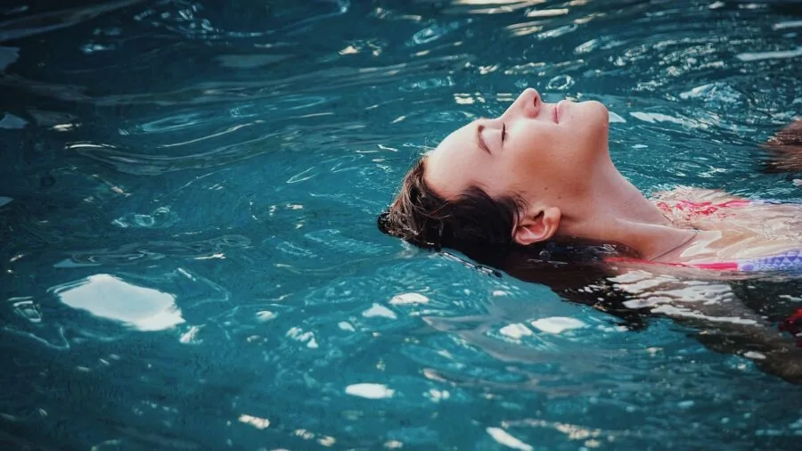 Woman enjoying time in swimming pool, experiencing comfort and relaxation in water