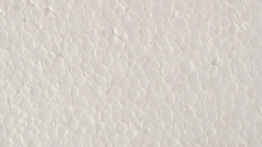 Woman examining different foam block textures and densities for yoga practice selection