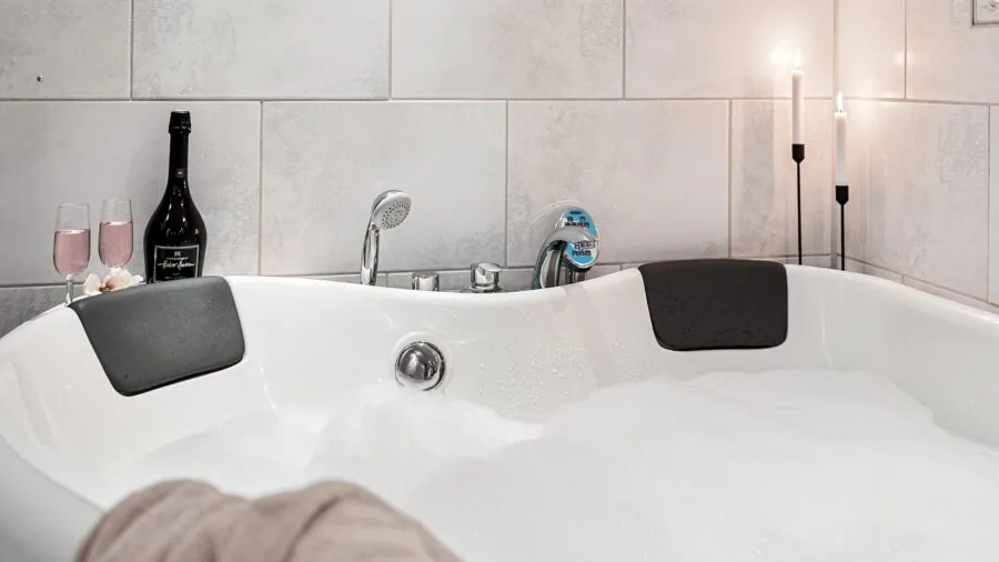 Woman examining different shampoo bottles in a bright bathroom, comparing options for hair care routine