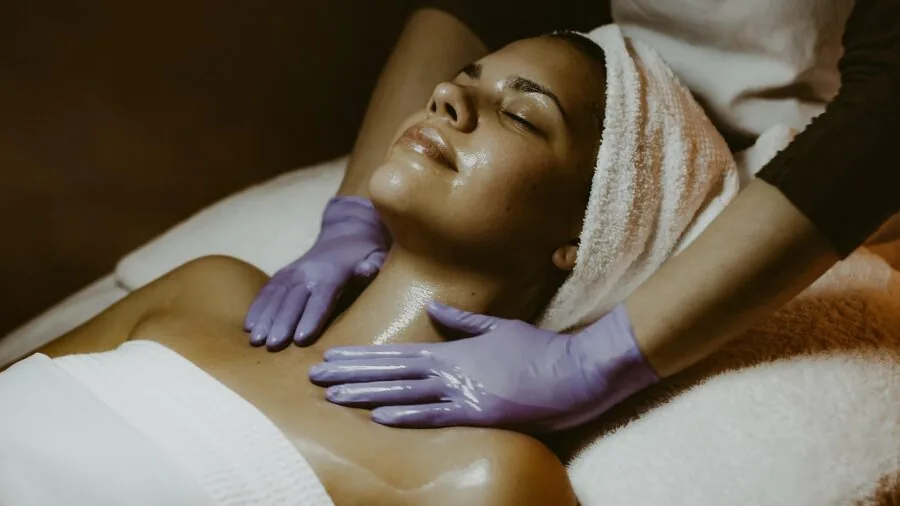 Woman examining her glowing healthy skin in natural light, representing skin wellness and beauty care