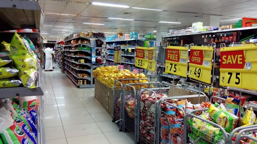 Woman examining product options while shopping, comparing prices and choices in store