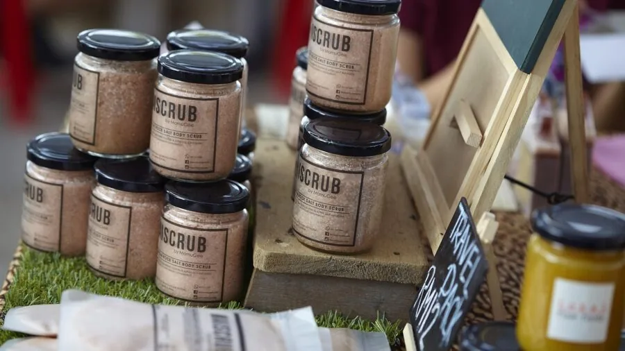 Woman examining skincare product ingredients and label information before purchase