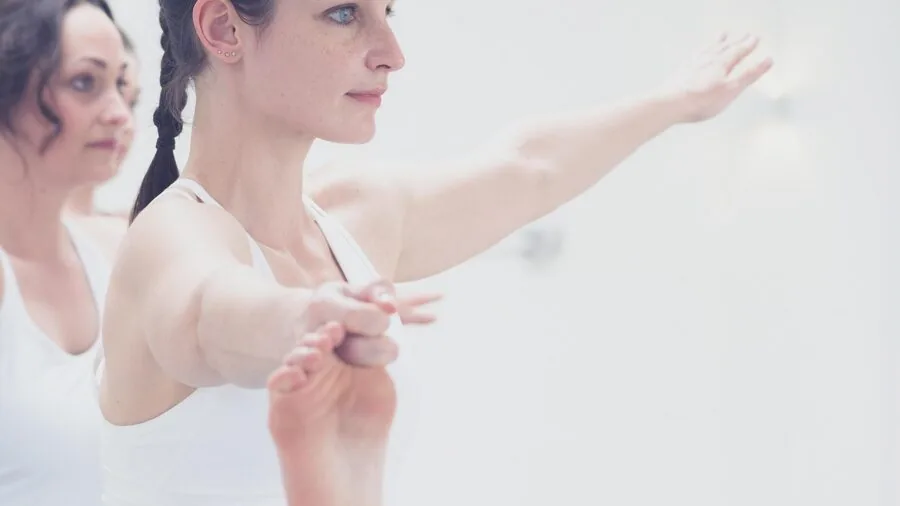 Woman exercising outdoors, perspiration visible on athletic clothing during physical activity