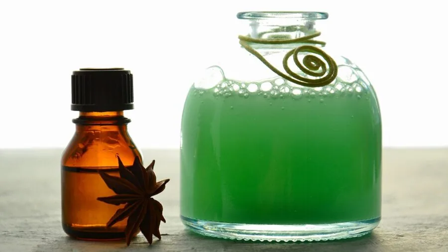 Woman experiencing pleasant scent from hair care product in modern bathroom setting
