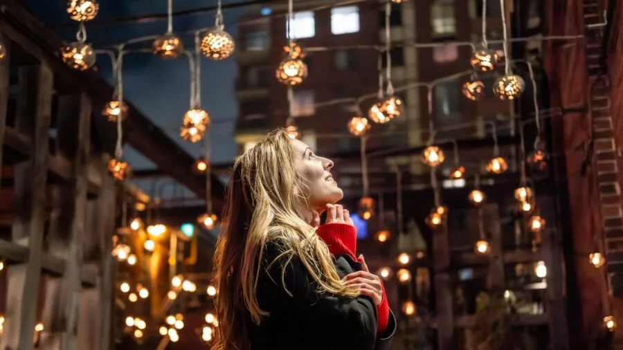 Woman exploring different perfume scents from sample vials in natural light