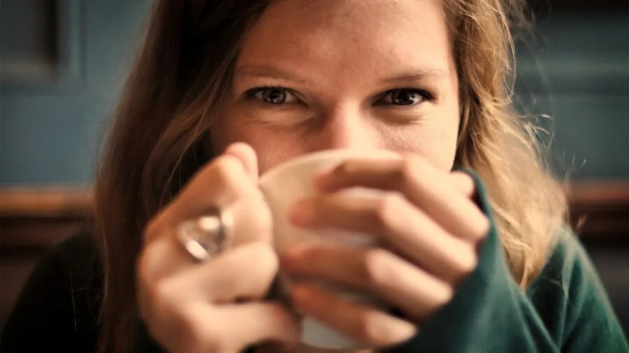 Woman in casual clothing adjusting jewelry comfortably against her skin