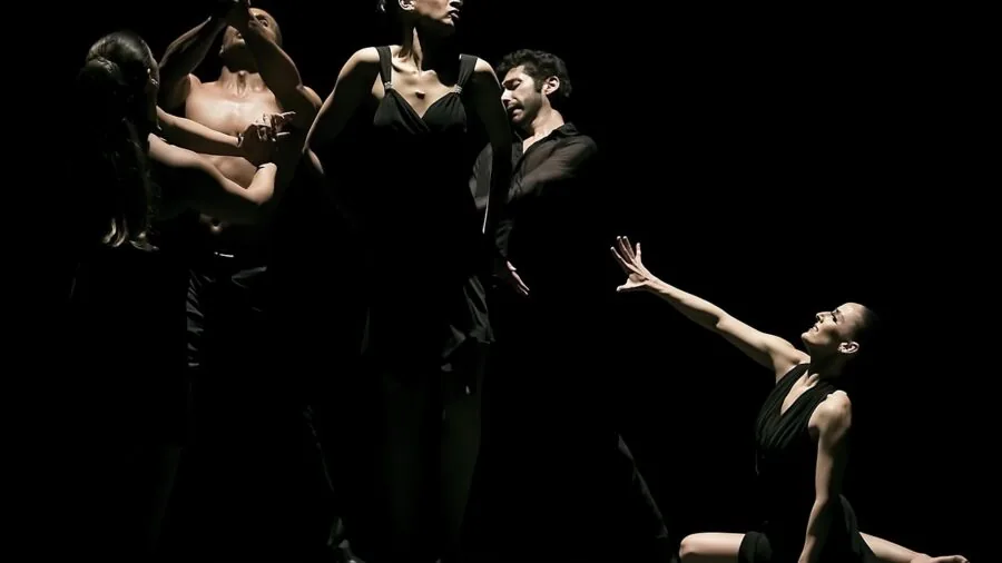 Woman in formal gown dancing freely at evening celebration, showcasing movement and comfort in elegant attire